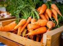 orange carrots on brown wooden crate