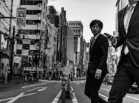 man in suit passing on the road