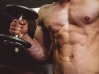 man holding black dumbbell